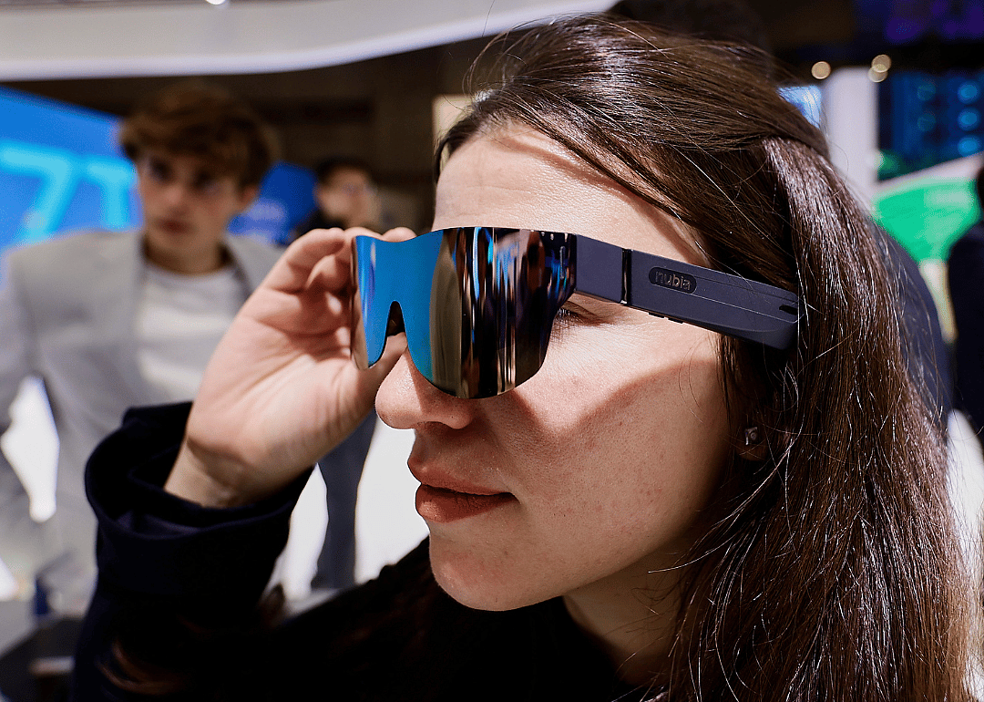 A woman trying on augmented reality glasses.