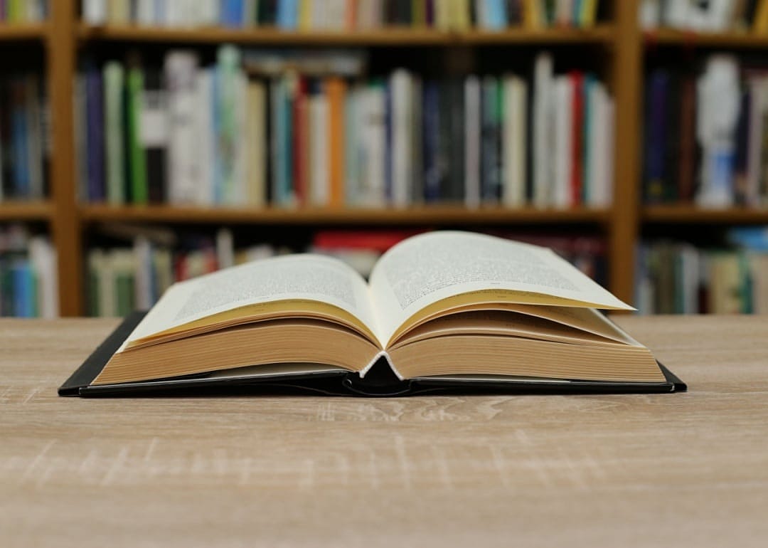 A book open on a library table.