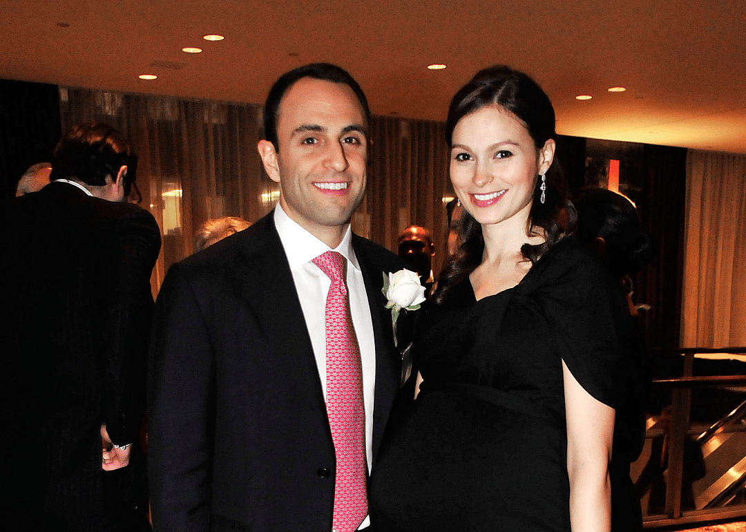 Scott and Elena Shleifer dressed in black at a banquet dinner.