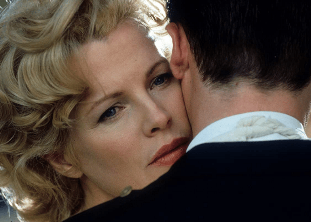 Kim Basinger hugging a man.