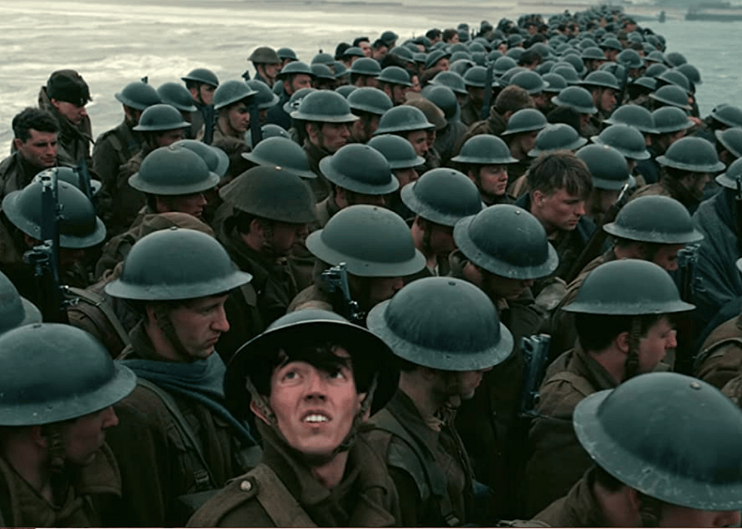 A pier covered in soldiers waiting to board a boat.