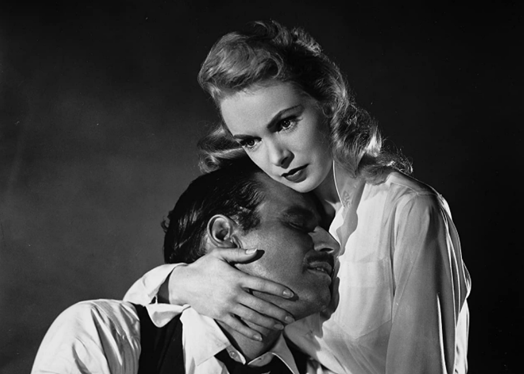 Charlton Heston and Janet Leigh hugging.
