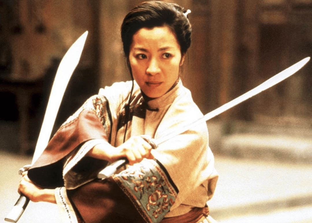 A woman with two swords ready to fight.