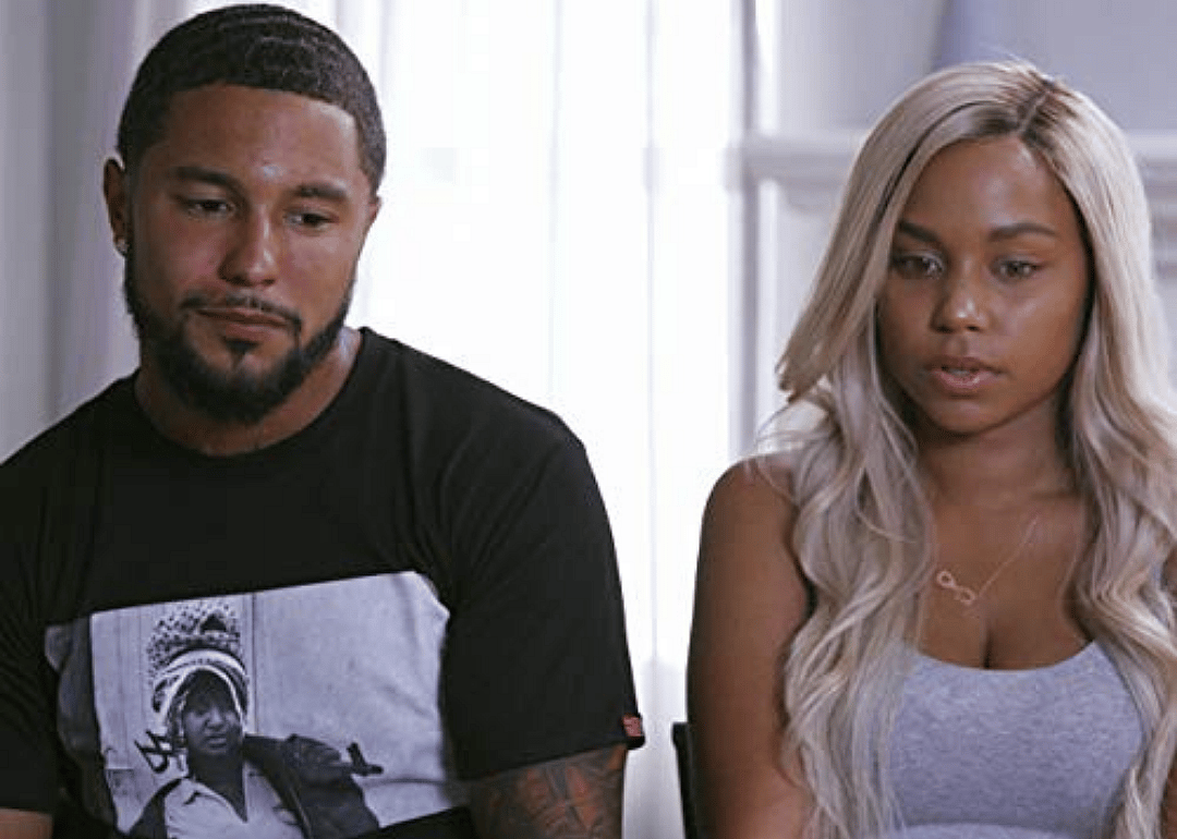 A couple sits together in an interview.