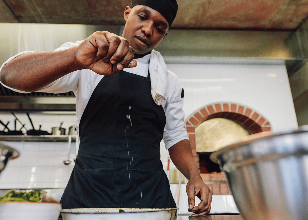 A restaurant cook prepares a dish