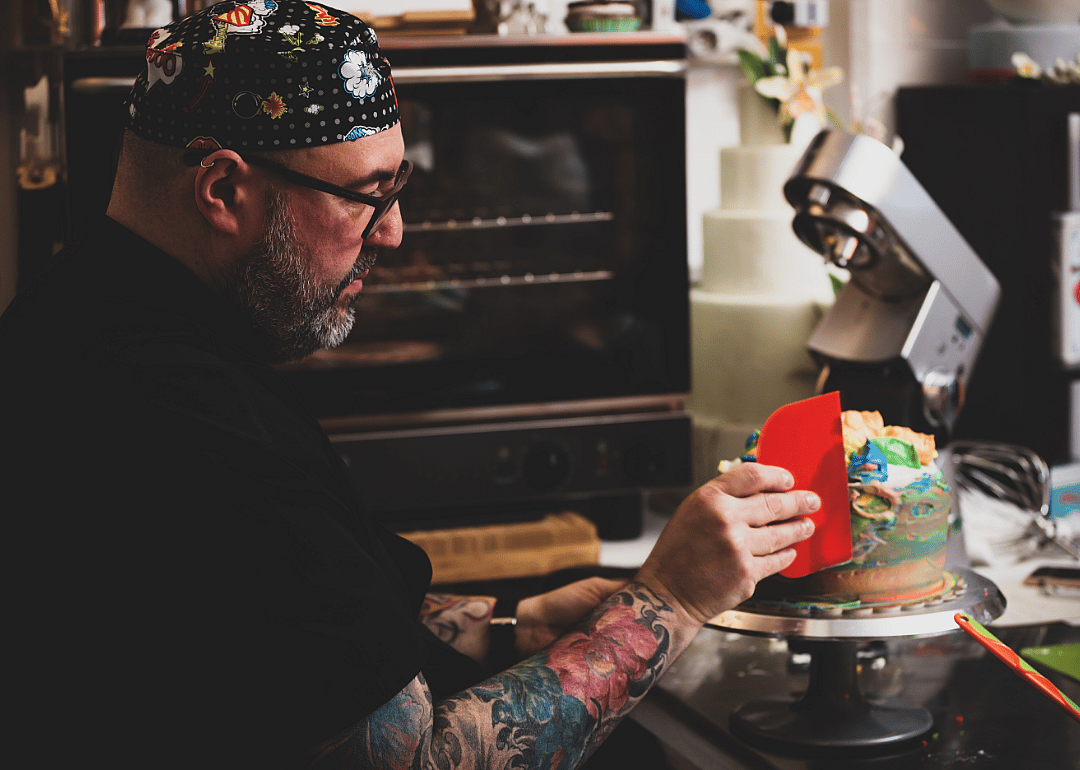 A baker works on a cake