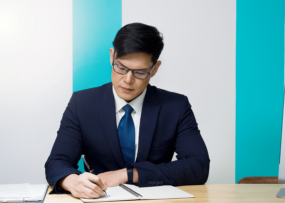 Counter clerk writes in a notebook