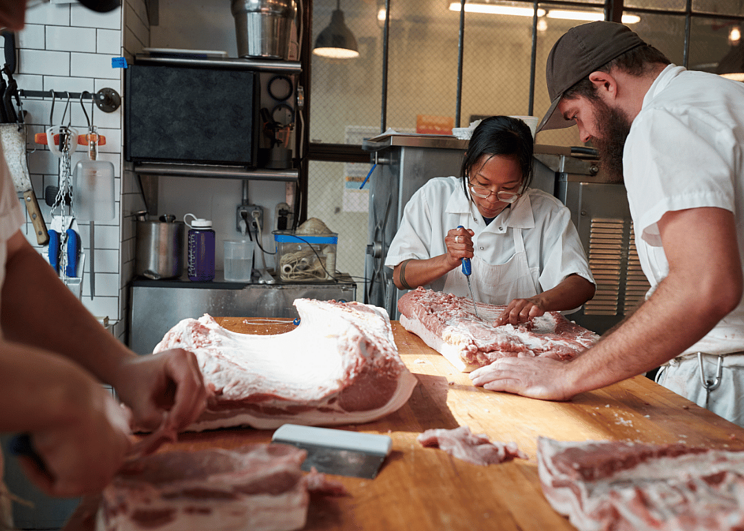 Butchers cutting meat