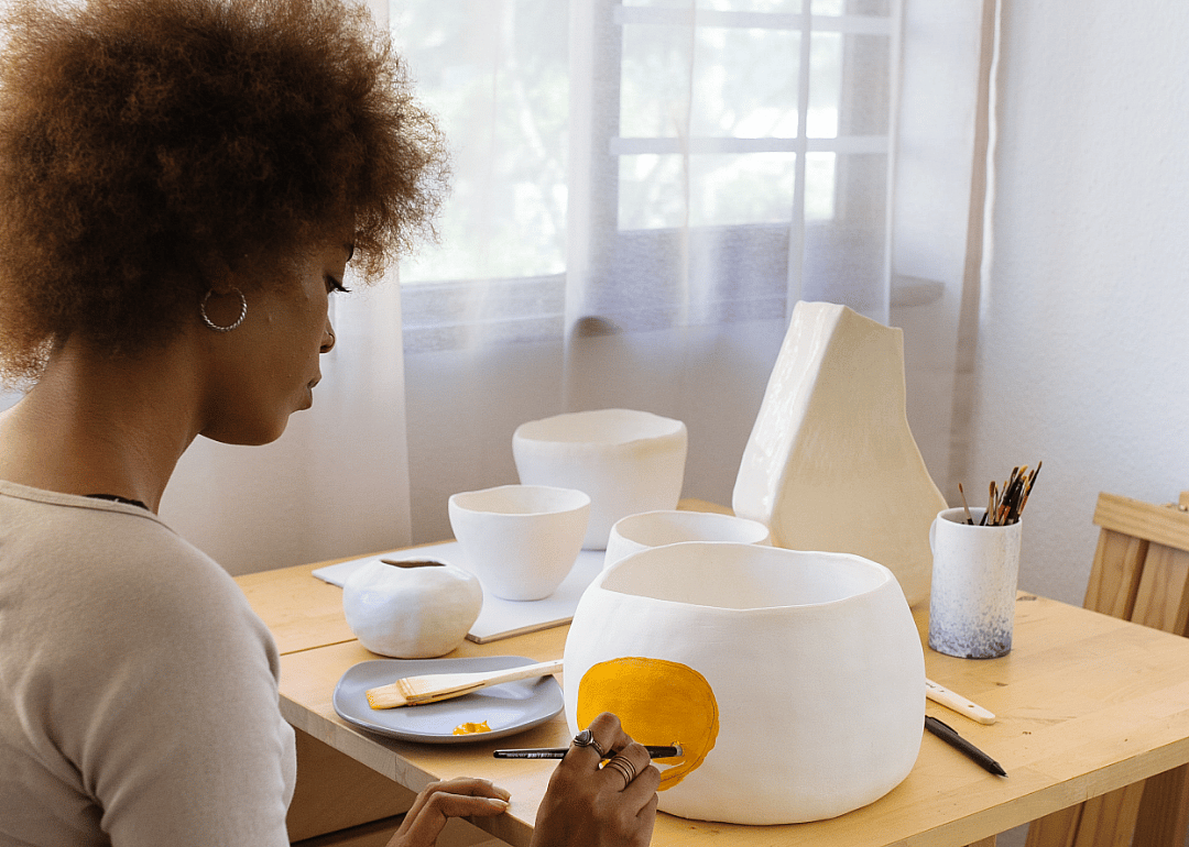 Painter decorates a piece of pottery