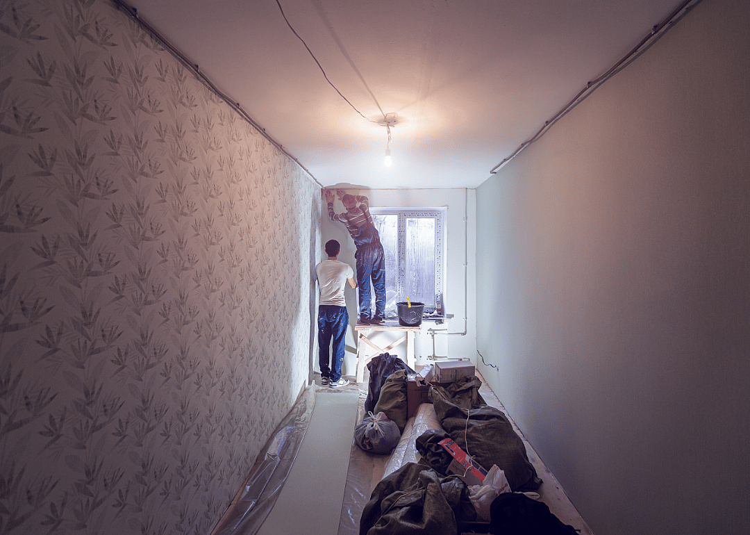 Paperhangers working in a hallway