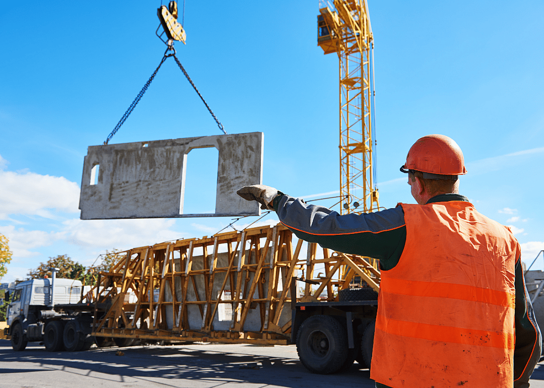 A worker directs a winch operator