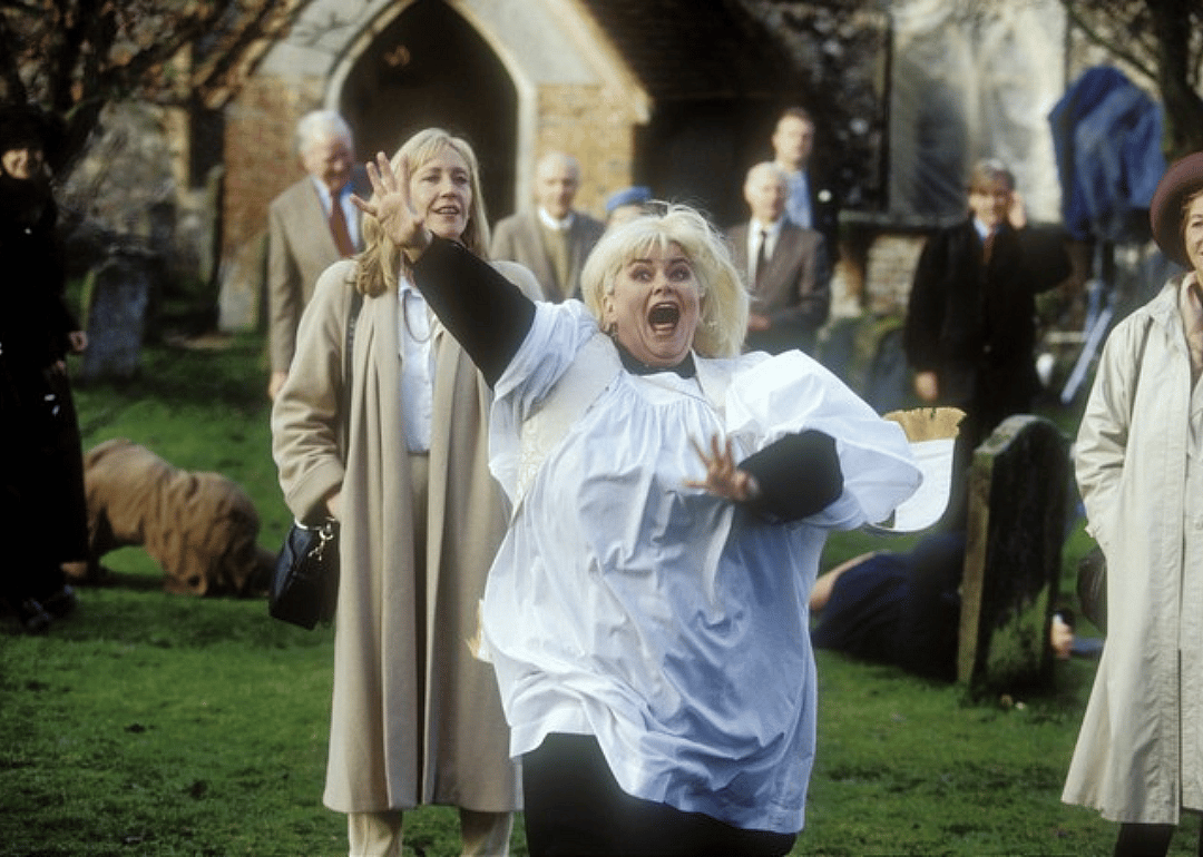 An excited woman running in front of a church.