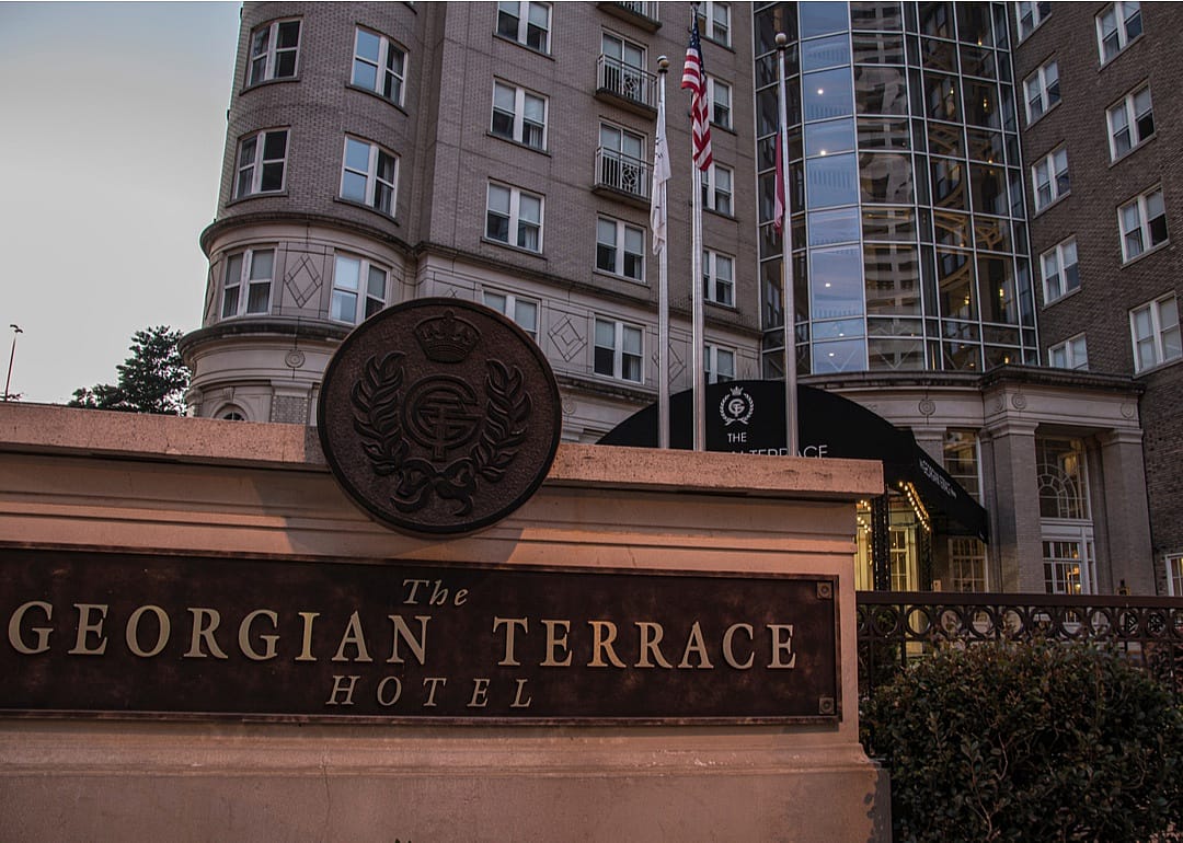 The Georgian Terrace hotel entrance sign and building at dusk.