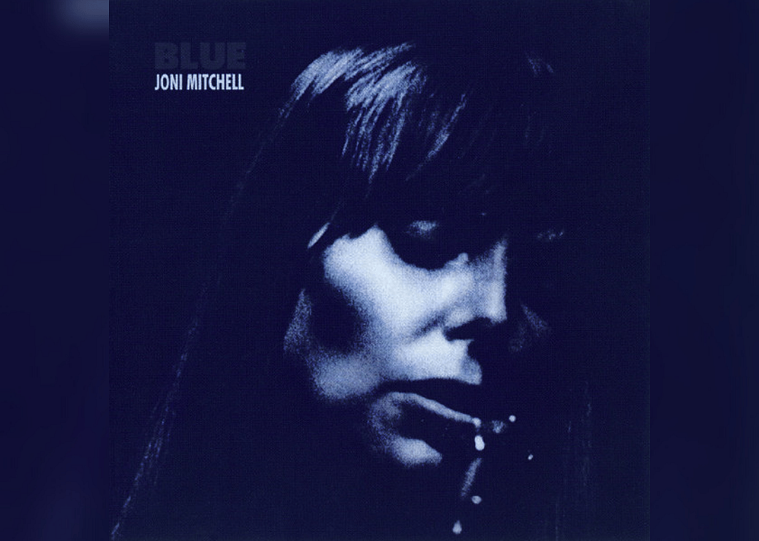 Dark blue close-up of Joni Mitchell.