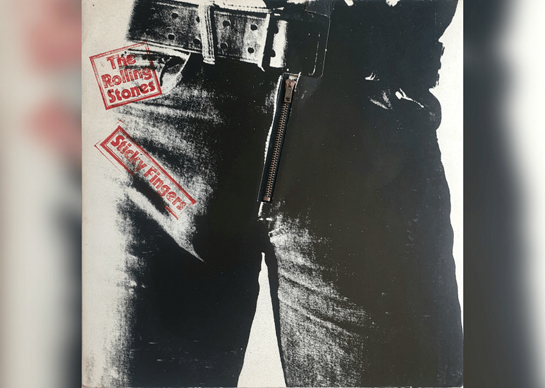A black and white close-up of the zipper on blue jeans.