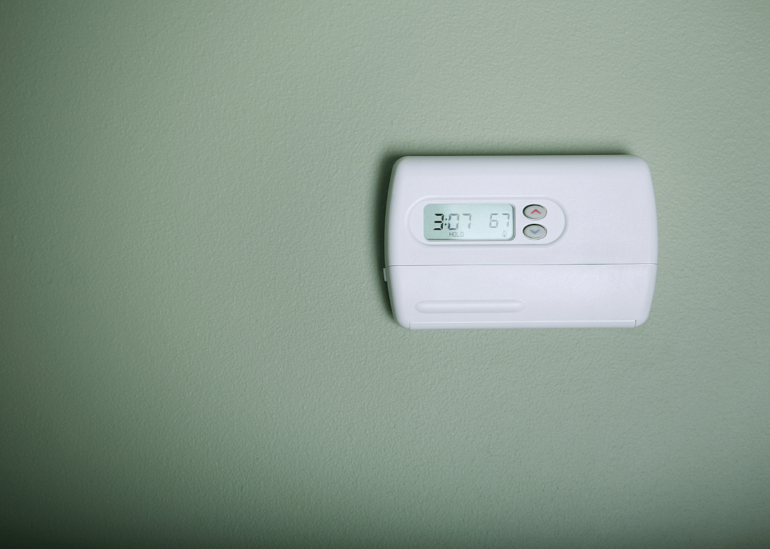 Thermostat on a sage green wall.