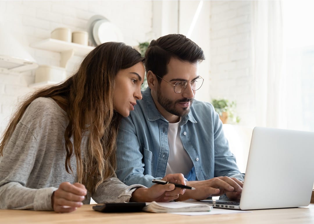 Man and woman looking at somthing on a computer screen.