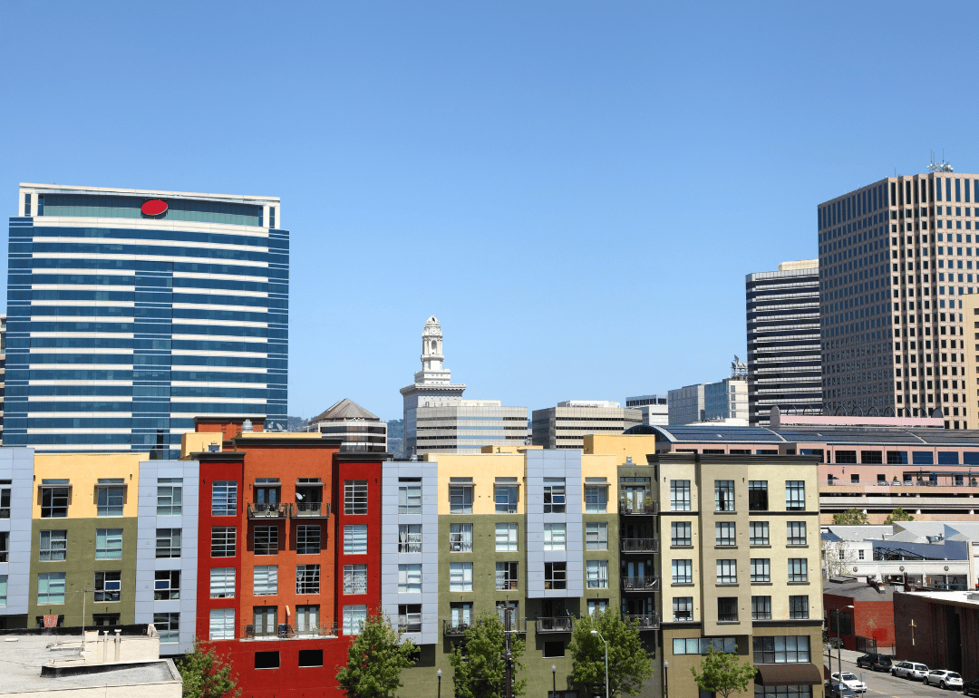 Colorful apartments in front of tall buildings in downtown.