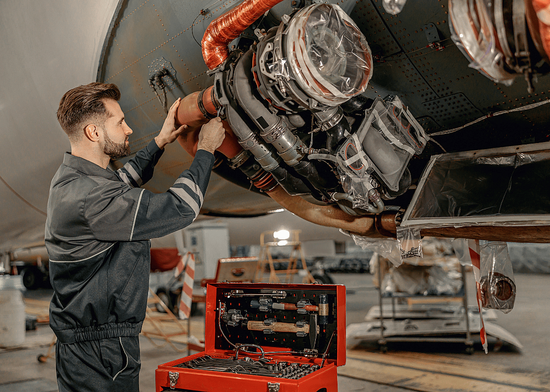 An aviation mechanic working on an airplane.