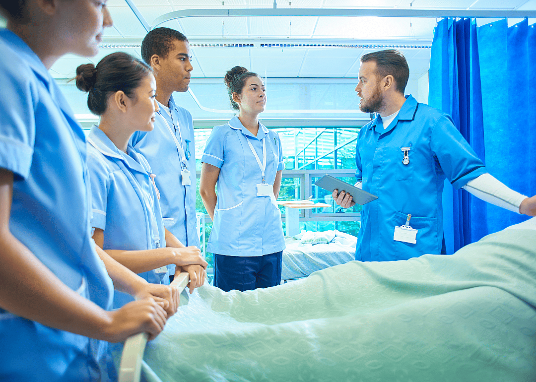Students in a hospital room for nursing training.