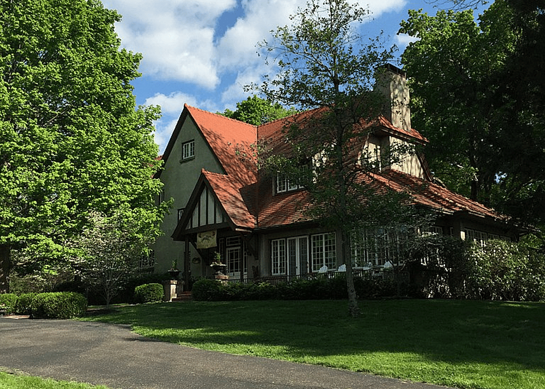 A historic stucco home with a multi-gabled roof.