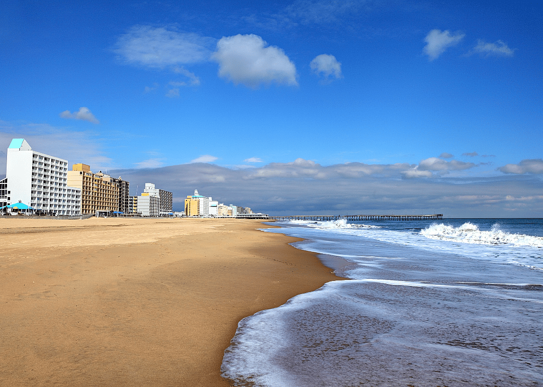 A long beach lined with buildings.