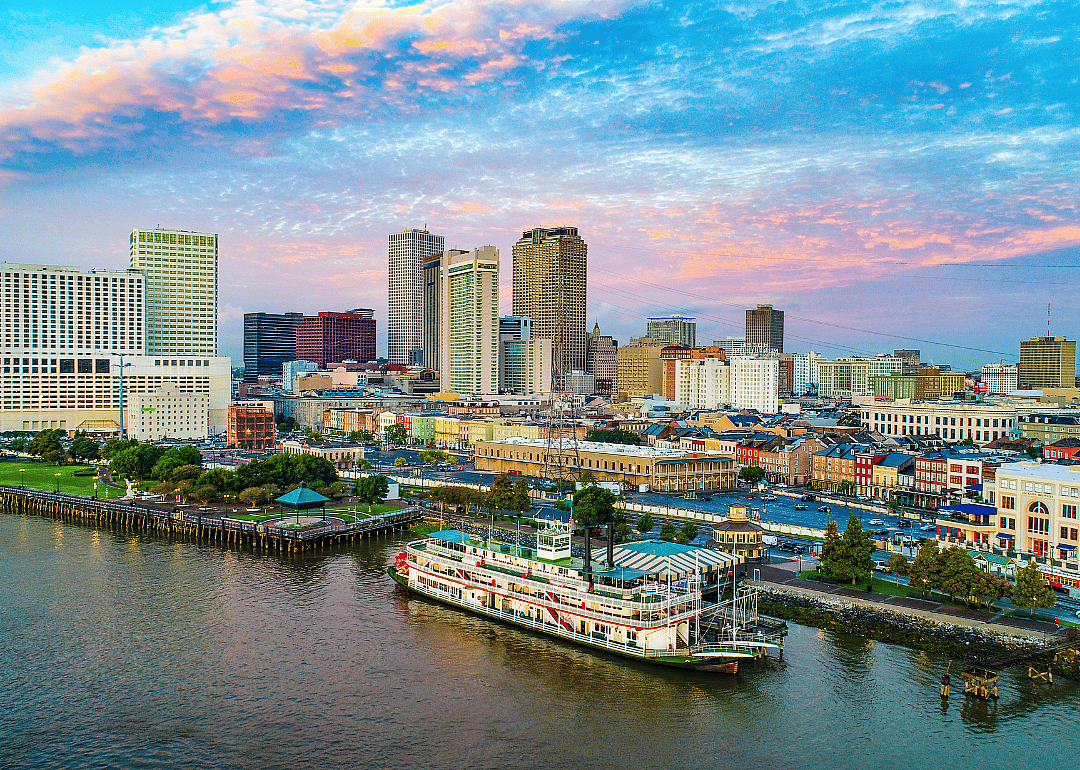 Boats on the water in New Orleans, Louisiana and downtown in the background.