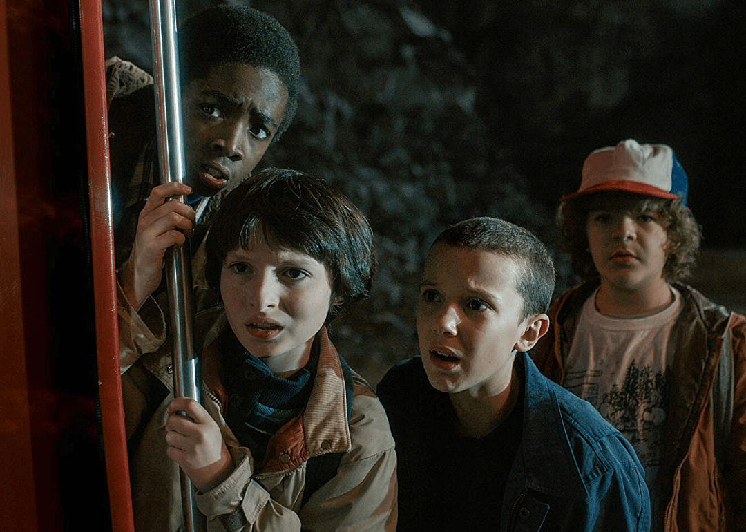Four kids looking at something mysterious.