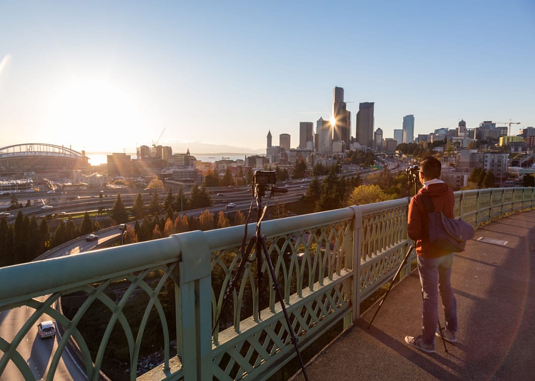 A photographer takes images on a tripod over downtown.