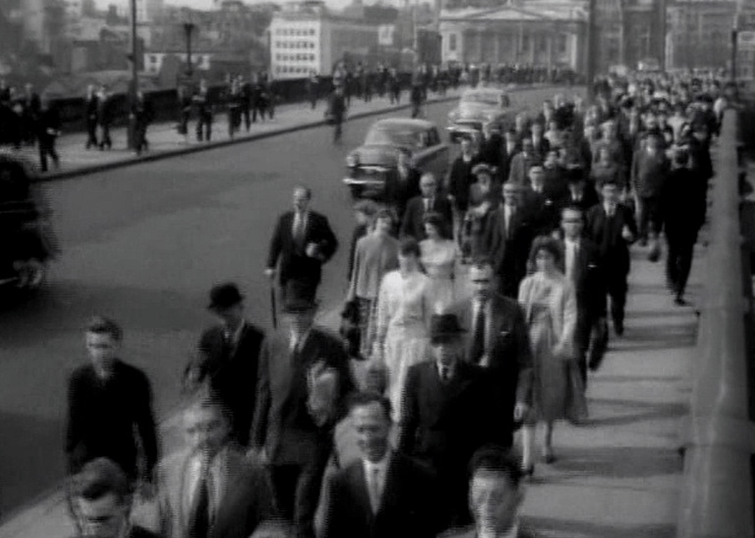 Business people walking on the sidewalks in the 50s.