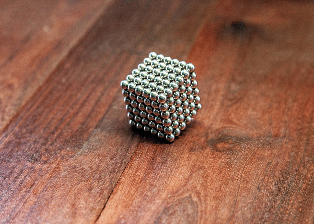 A square block made from silver magnet balls.