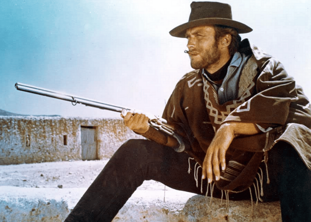Clint Eastwood holing a long gun.