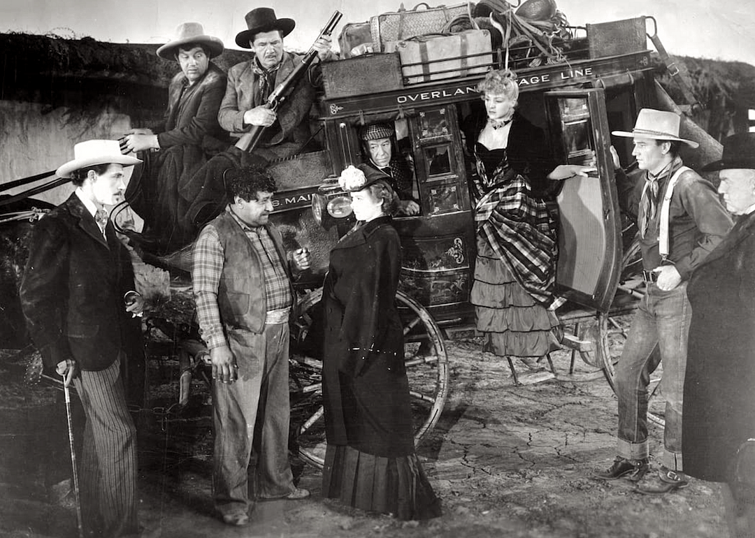 A group of people around a stagecoach.