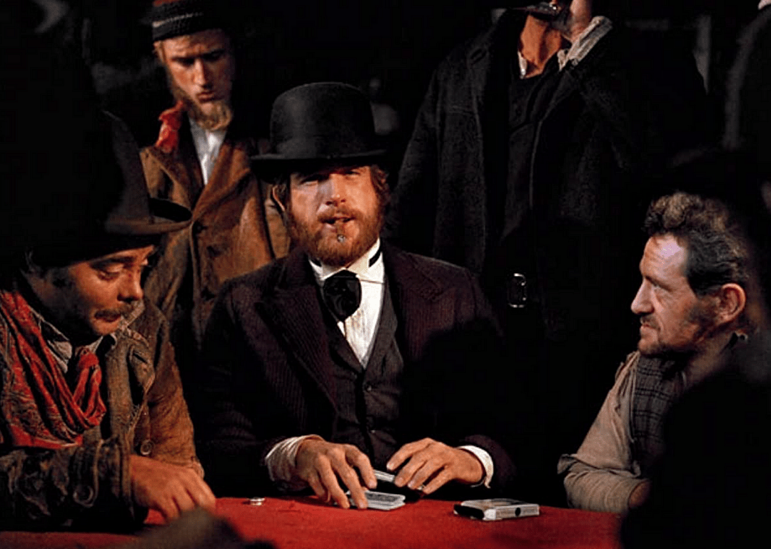 A group of men gambling in a western setting.