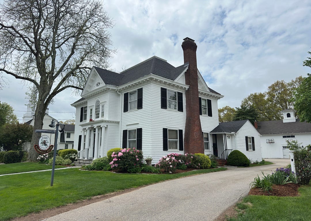 A white and black historic home.