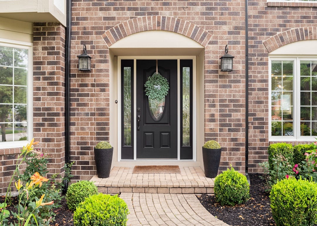 The front door of a brick home.