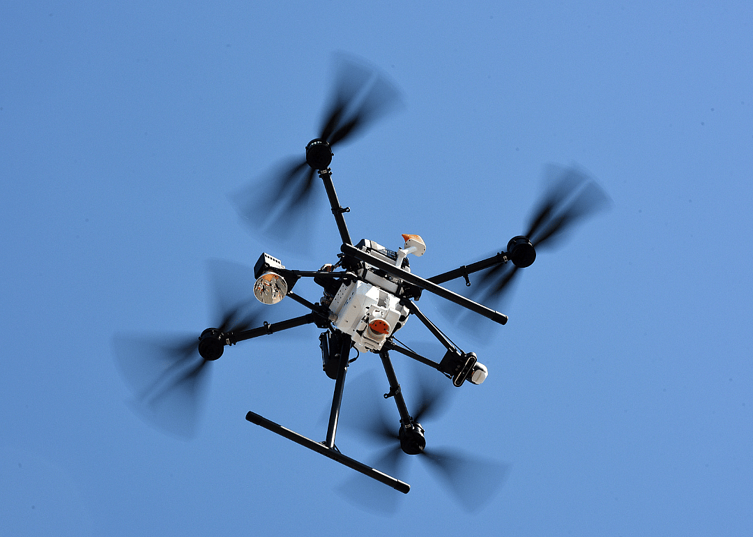 A drone in mid-flight making a delivery.