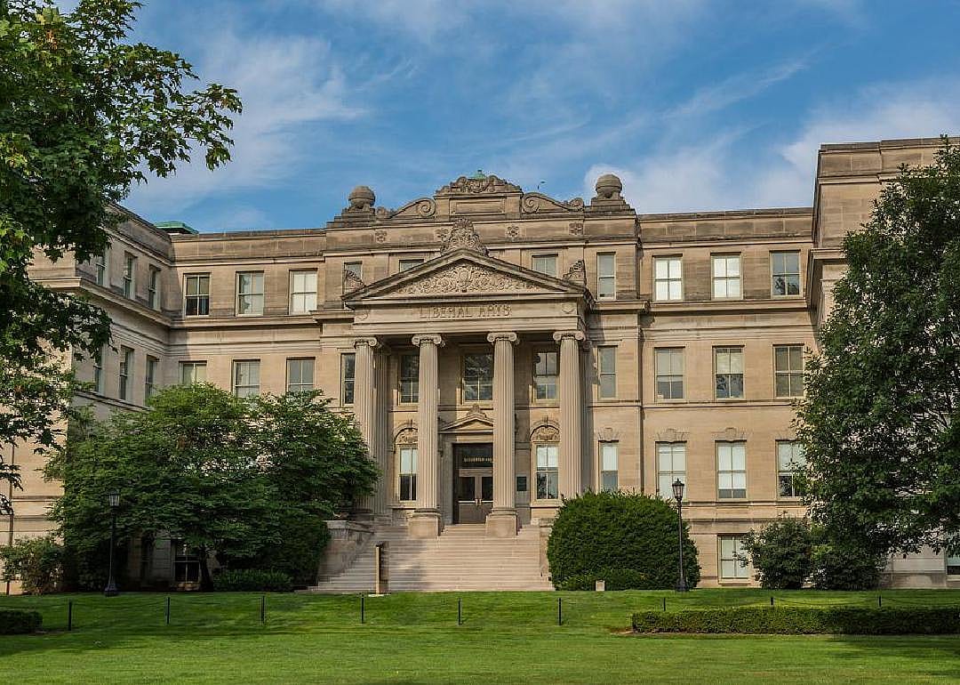 A large greek style stone building with columns.