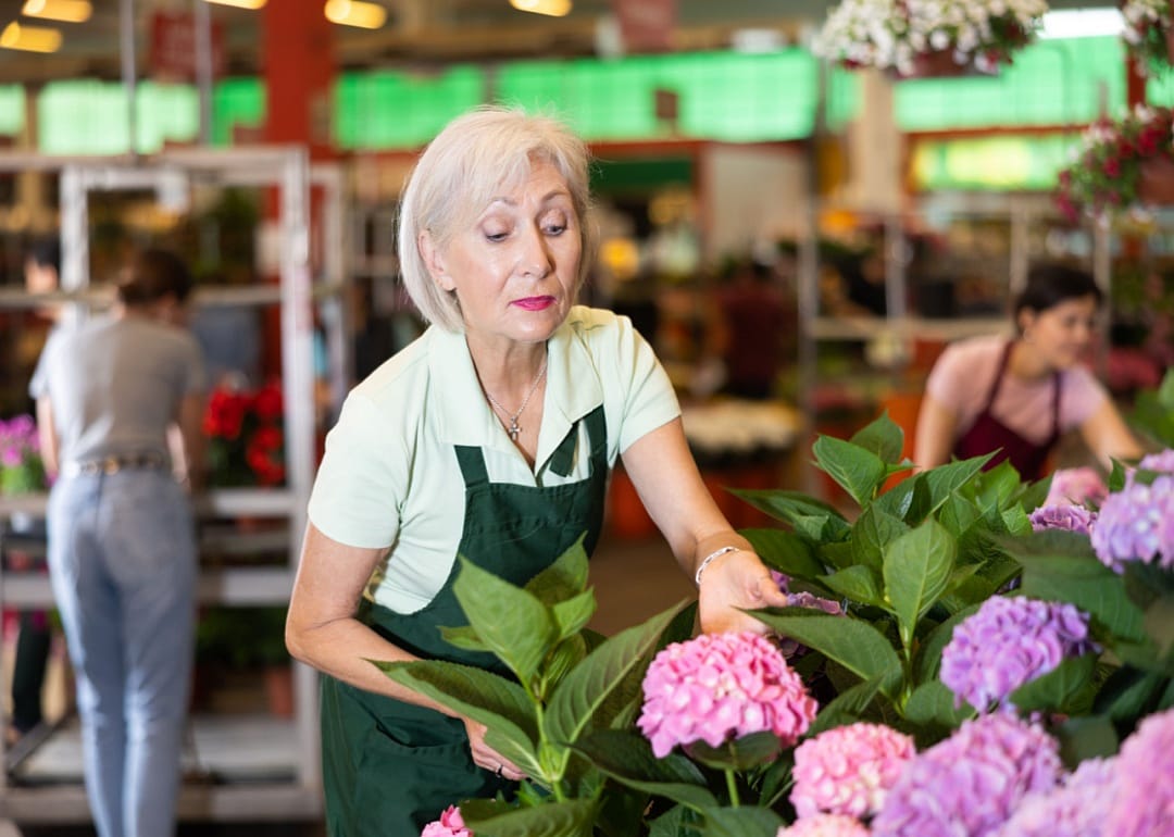 An older woman working as a florist.