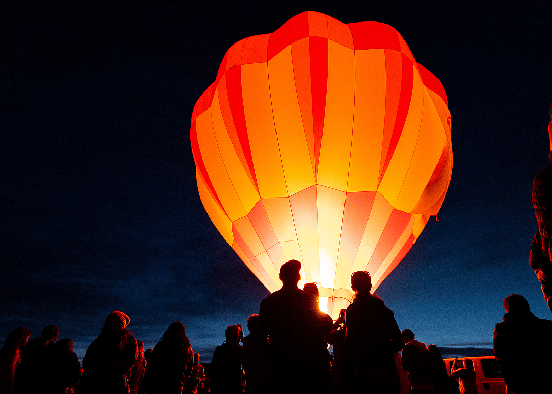 A hot air balloon glowing at night.