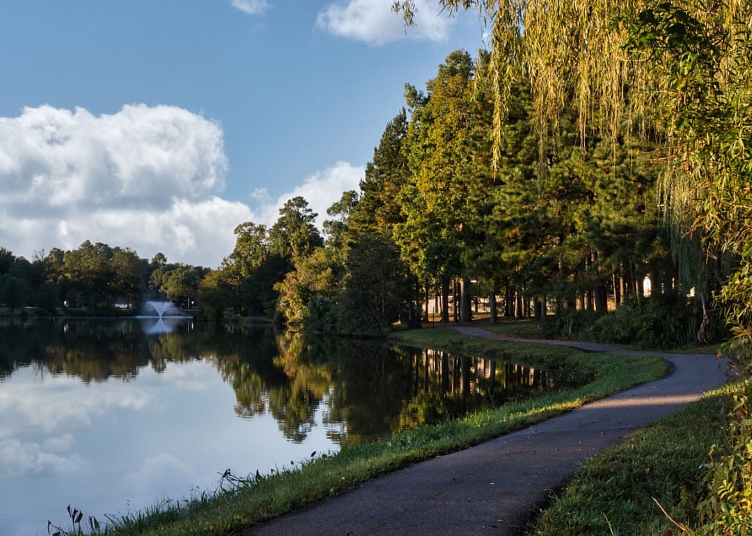 A walking path next to a lake.