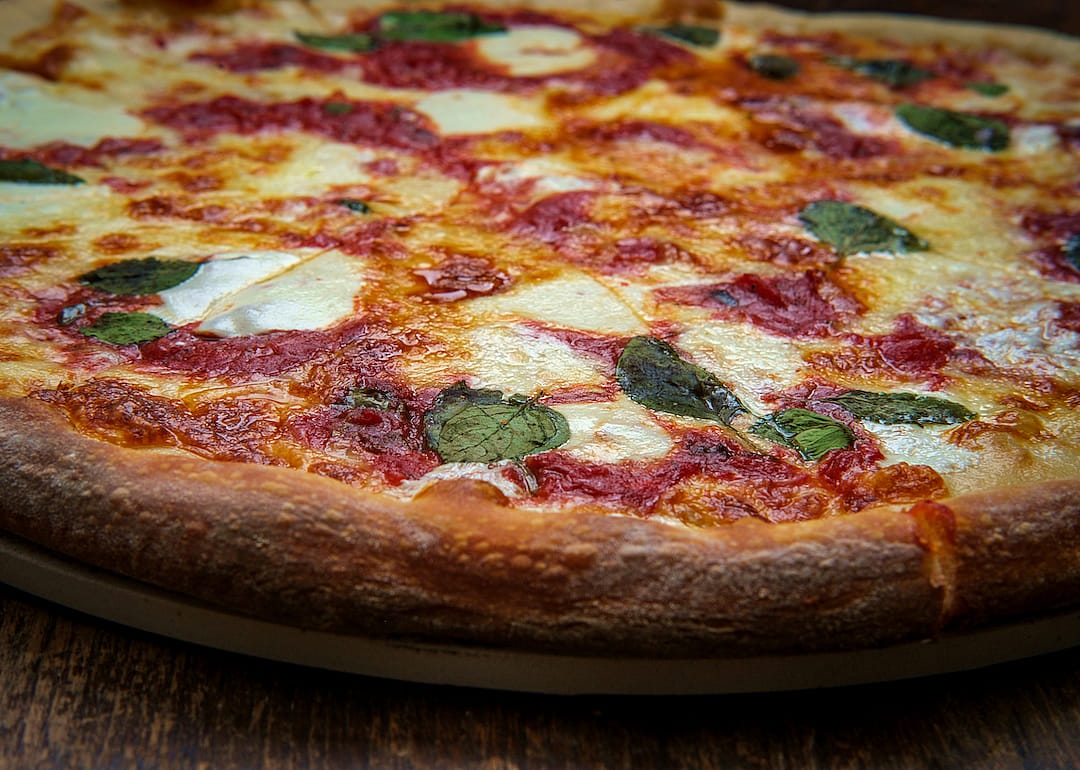 Margherita pizza on pizza tray.