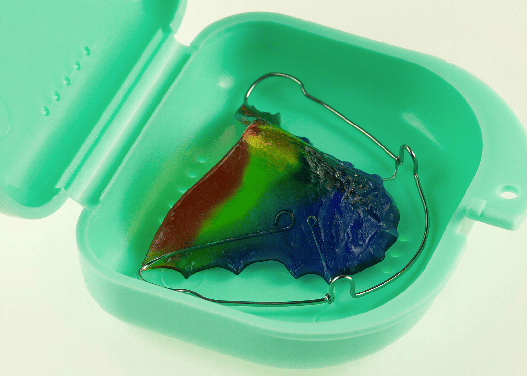 A colorful retainer in a green case.