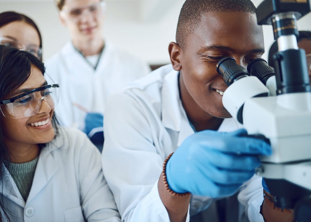 Science students using a microscope.