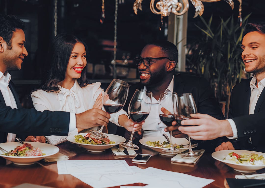 A group of business people at a restaurant for dinner inside