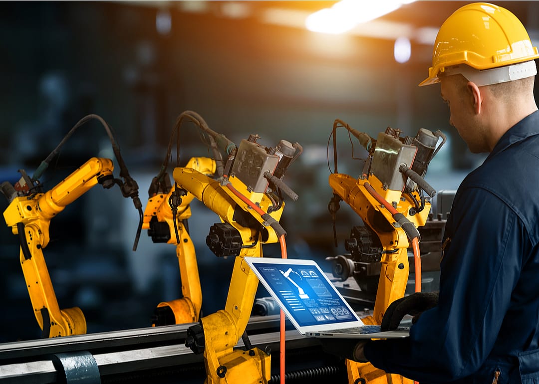 A man operating smart technology in a manufacturing plant