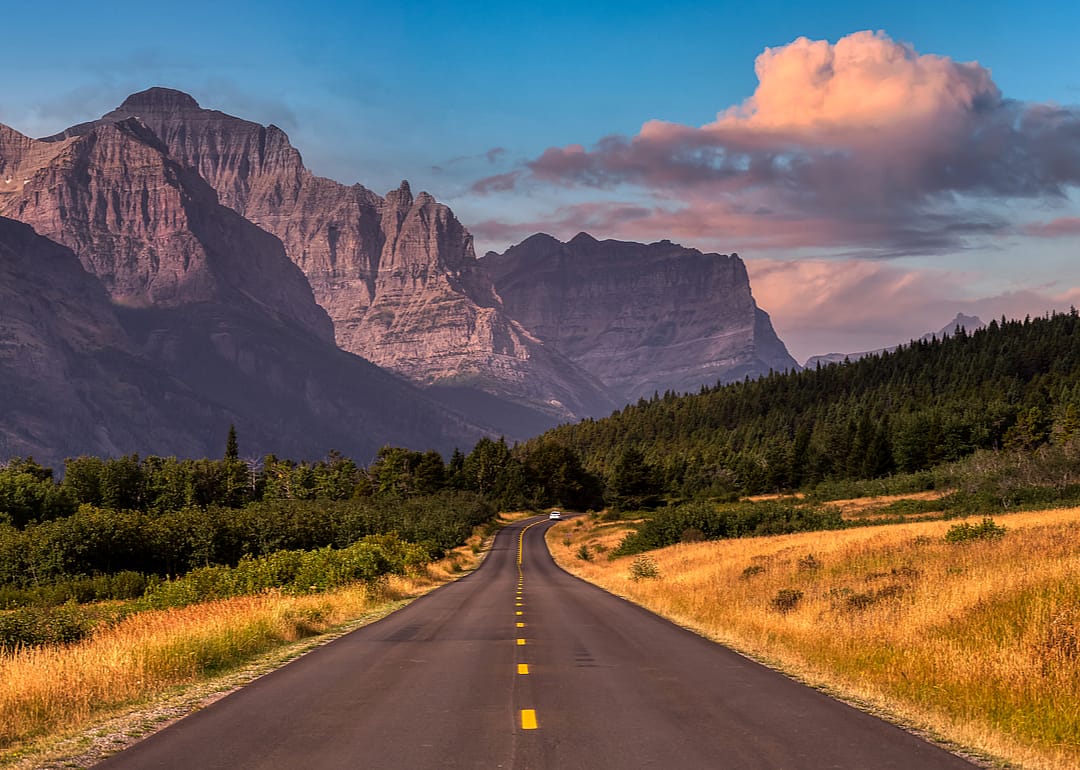 A scenic highway in St. Mary, Montana, with the Rocky Mountains in the background 