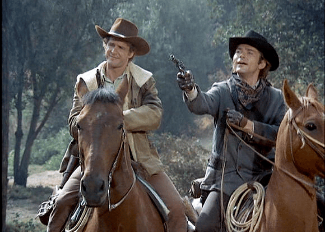 Two cowboys on horseback.