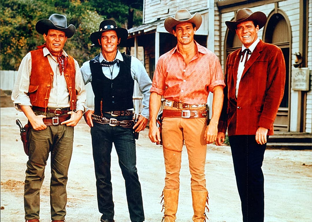Four smiling cowboys.
