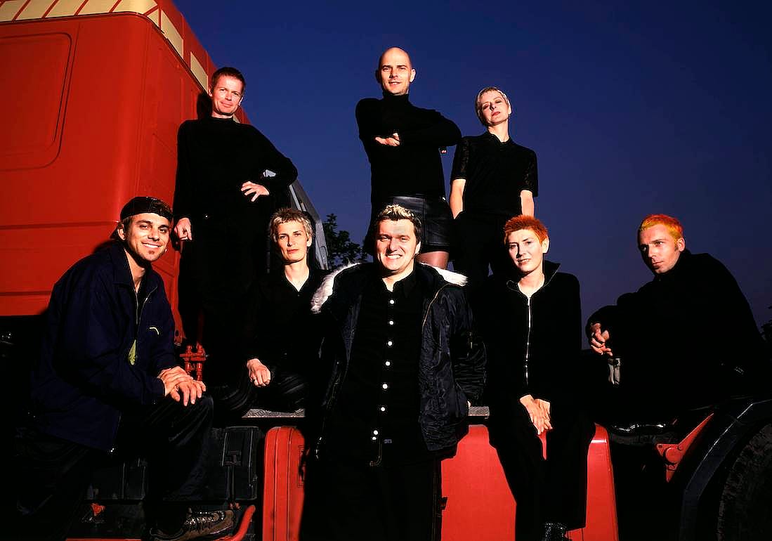 Chumbawamba, all dressed in black, in a portrait taken in the '90s.